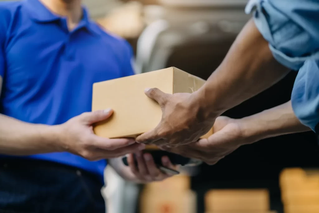 delivery person handing package to customer close utc